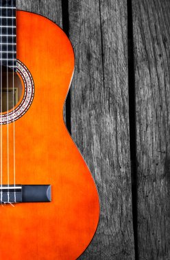 Spanish Guitar on wood background clipart