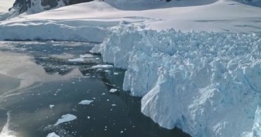 Yakın çekim güneşi okyanus antenini yansıtıyor. Eriyen buz, buzul kıyıları karları. İklim değişikliği, küresel ısınma