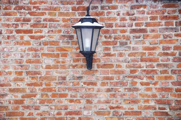 Lantern on a brick wall background — Stock Photo, Image
