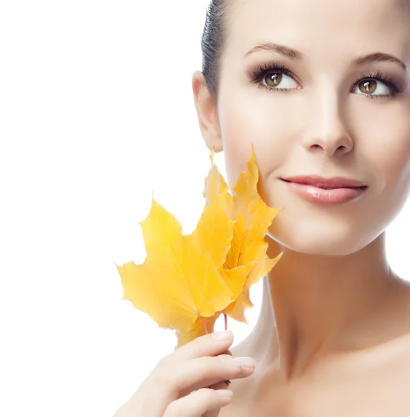 Woman beauty closeup portrait with yellow leave face skin — Stockfoto