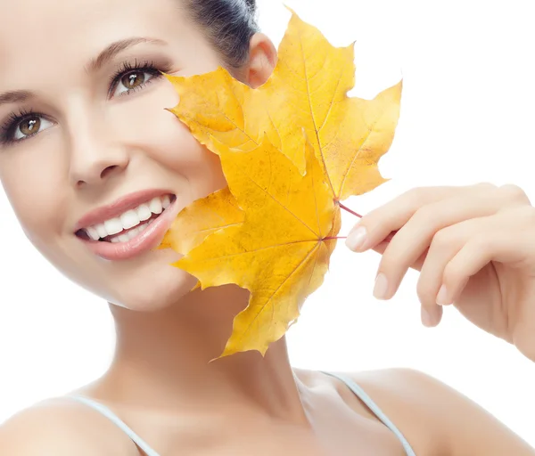 Woman beauty closeup portrait with yellow leave face skin — Stok fotoğraf