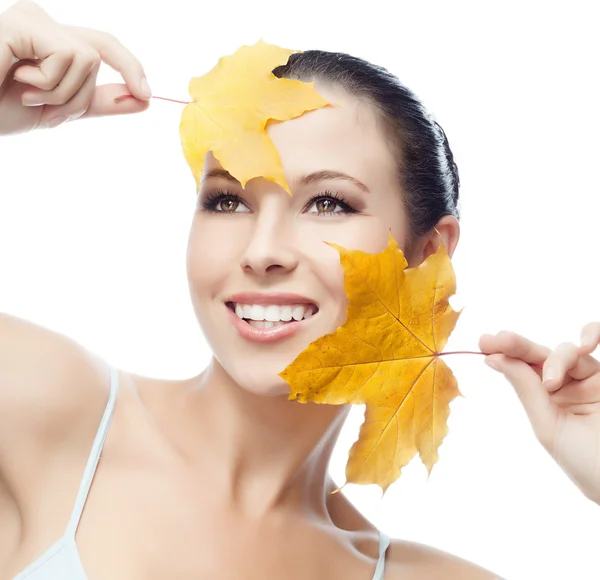 Woman beauty closeup portrait with yellow leave face skin — Stok fotoğraf