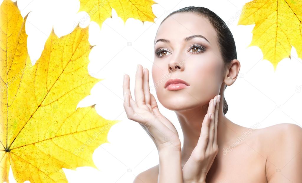 woman beauty closeup portrait with yellow leave face skin