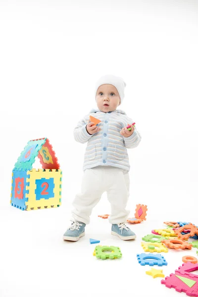 Little child baby boy playing with puzzles — Stock Photo, Image