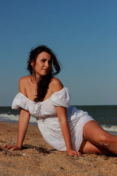 Beautiful young woman posing over the Black sea beach,East Crimea,Russia