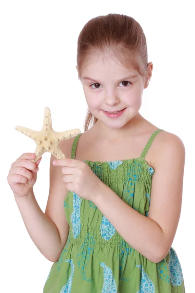 Little girl holding sea treasure — Stock Photo, Image