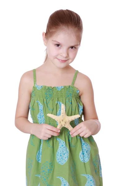 Little girl holding sea treasure — Stock Photo, Image