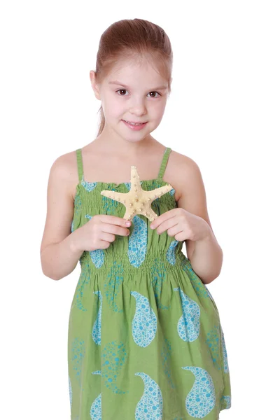 Little girl holding sea treasure — Stock Photo, Image