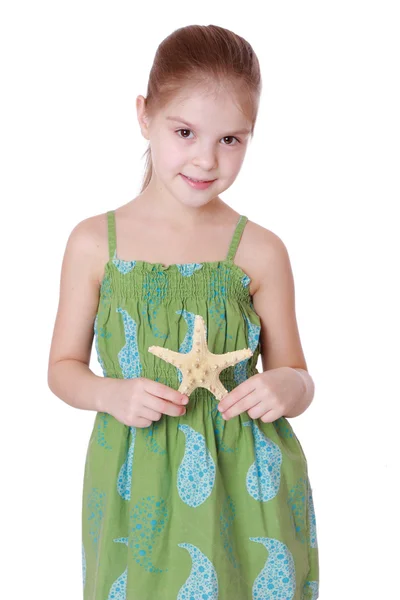 Little girl holding sea treasure — Stock Photo, Image