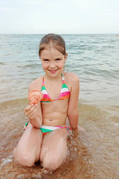 Seashell in kid hand — Stockfoto