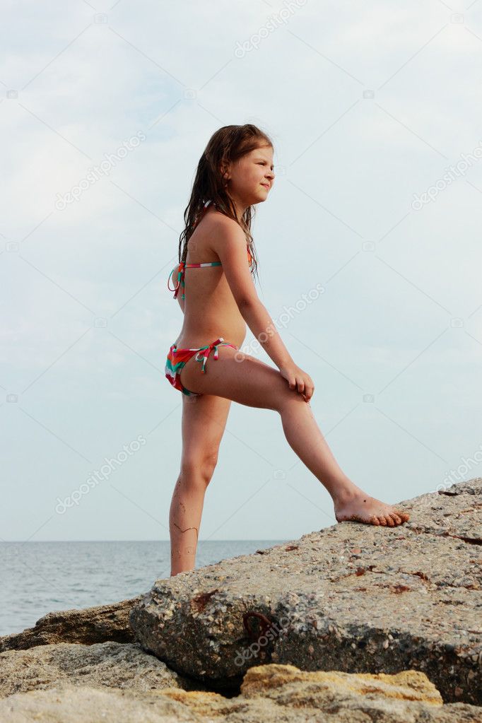 Summer vacation, lovely girl resting on the beach near water of Black Sea