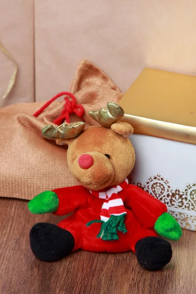 Christmas deer toy over presents — Stock Photo, Image