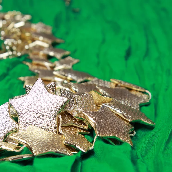 Golden stars over green background — Stock Photo, Image