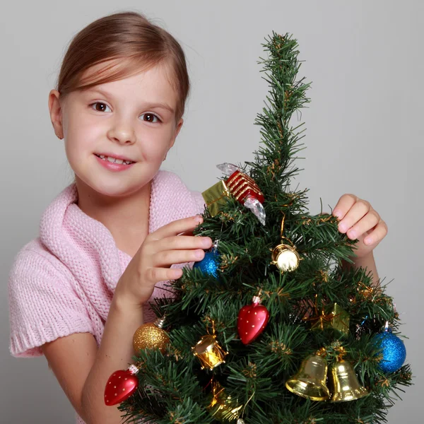 Child near a decorated Christmas tree — Stock Photo, Image