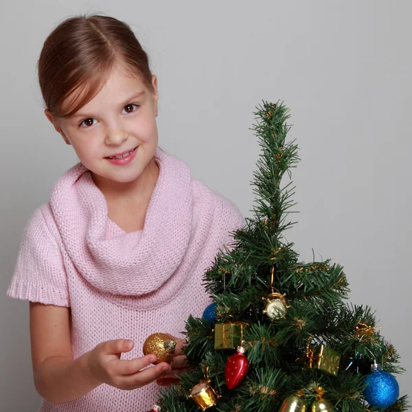 Child near a decorated Christmas tree — Stock Photo, Image