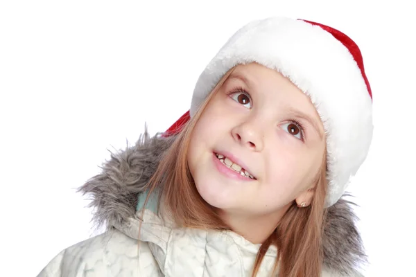 Urlaubsporträt eines fröhlichen Mädchens mit Weihnachtsmannmütze — Stockfoto