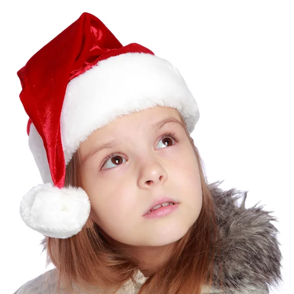 Retrato de férias de uma menina alegre com um chapéu de Papai Noel — Fotografia de Stock