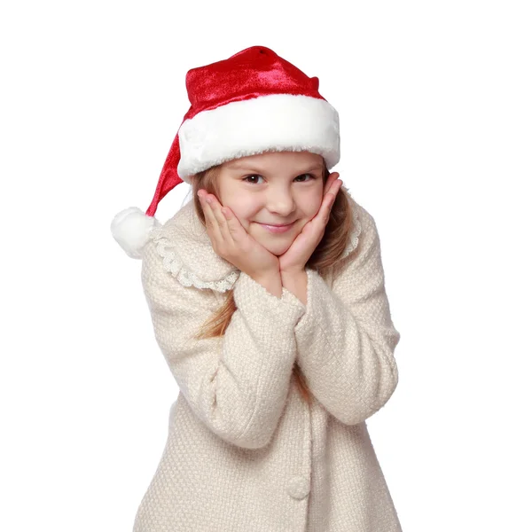 Charmant enfant dans un chapeau de Père Noël est heureux et rit — Photo