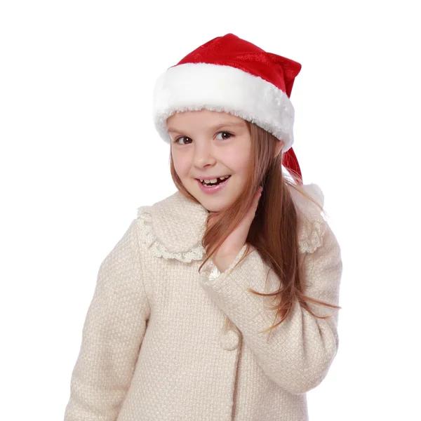 Lovely child in a Santa hat is happy and laughs — Stock Photo, Image