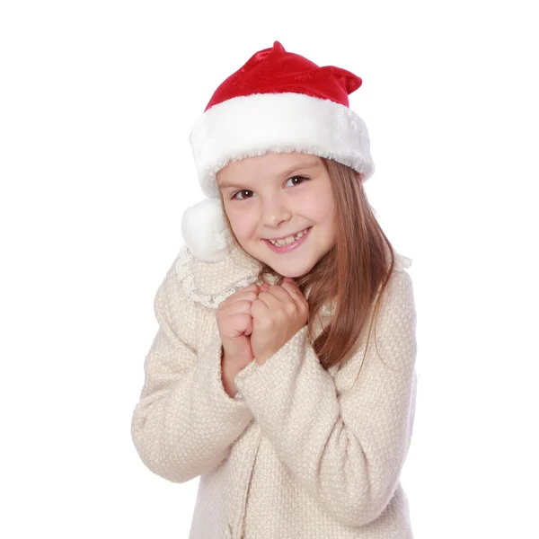 Liebliches Kind mit Weihnachtsmütze ist glücklich und lacht — Stockfoto