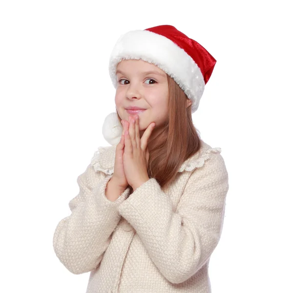 Mooie kind in een kerstmuts is blij en lacht — Stockfoto