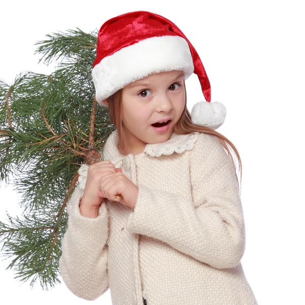 Chica joven positiva en el sombrero de Santa es feliz y riendo con el árbol de Navidad — Foto de Stock