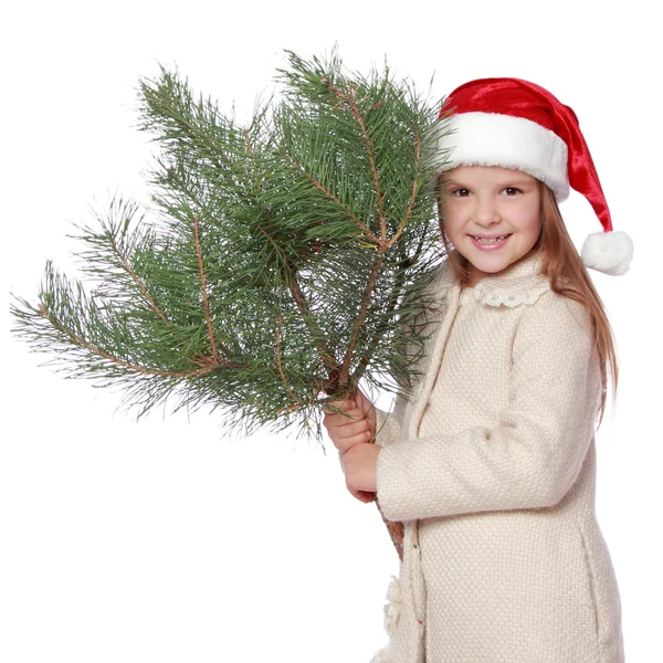 Noel Baba'nın şapkalı olumlu genç kız mutlu ve Noel ağacı ile gülen — Stok fotoğraf