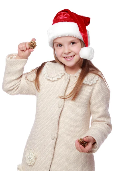 Charmant enfant dans un chapeau de Père Noël est heureux et rit — Photo