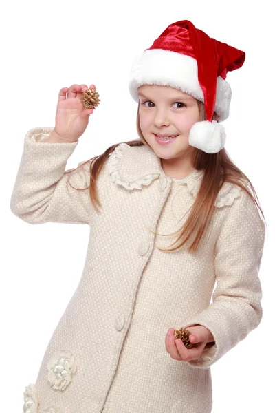 Charmant enfant dans un chapeau de Père Noël est heureux et rit — Photo