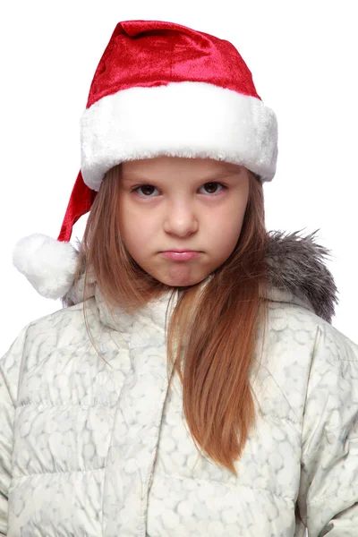 Retrato de férias de uma menina alegre com um chapéu de Papai Noel Fotografias De Stock Royalty-Free