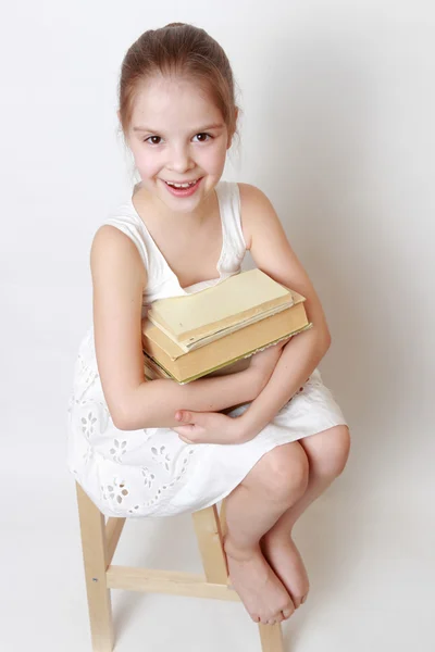 Ragazzo che tiene libri vintage Fotografia Stock