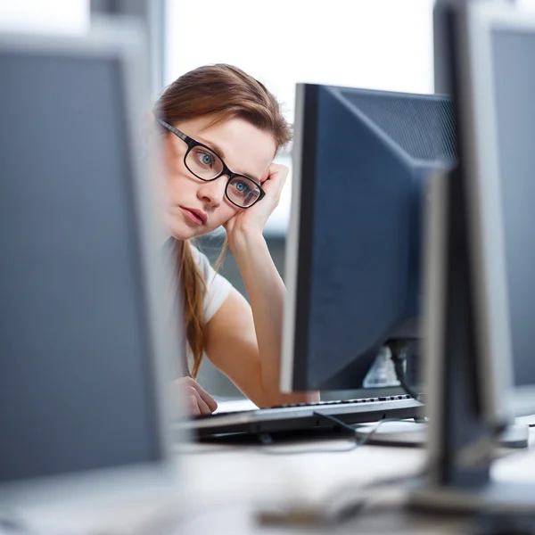 Estudante bonita, olhando para uma tela de computador desktop — Fotografia de Stock