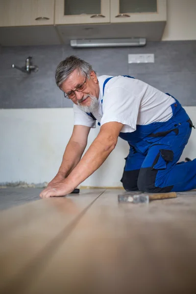 Close up of male hands lying parquet floor board/laminate flooring — Stock Photo, Image