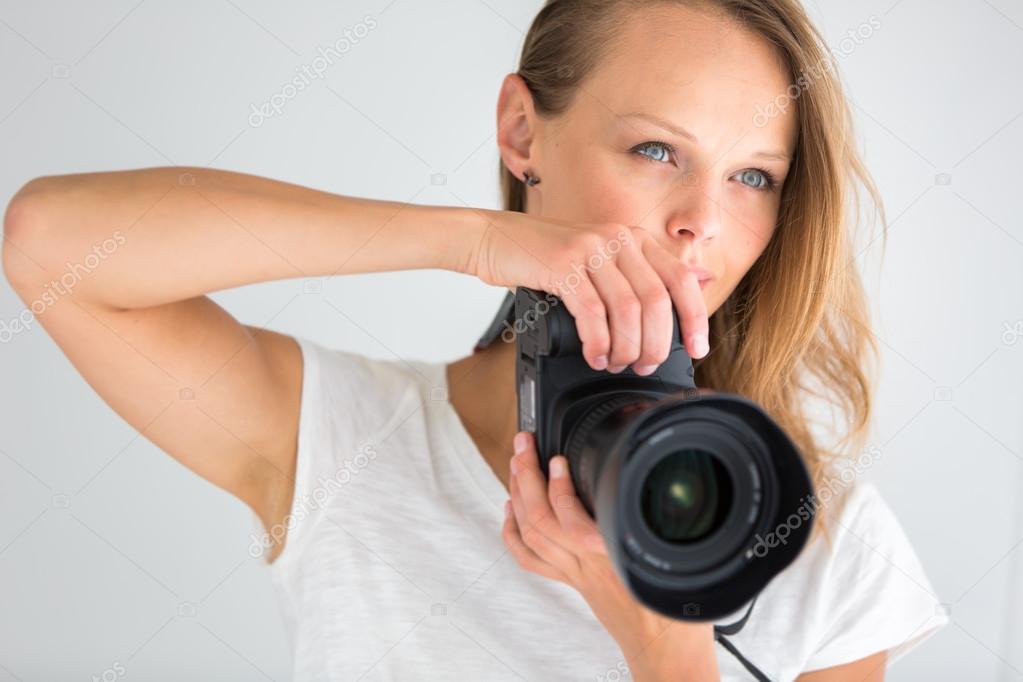 Pretty, female photographer with digital camera Stock Photo by