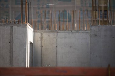 Construction site with a concrete slab and walls reinforced with steel