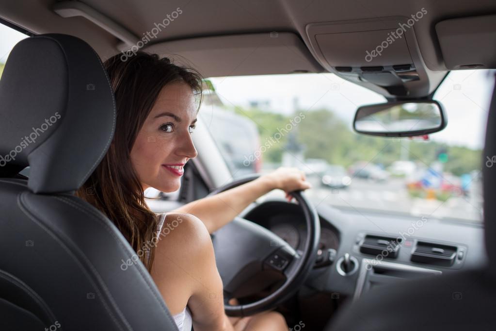 Woman driving a car, going home from work — Stock Photo © lightpoet