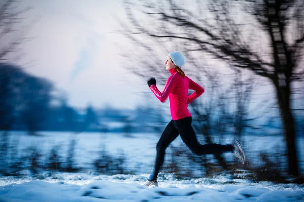 Woman running outdoors on a cold winter day