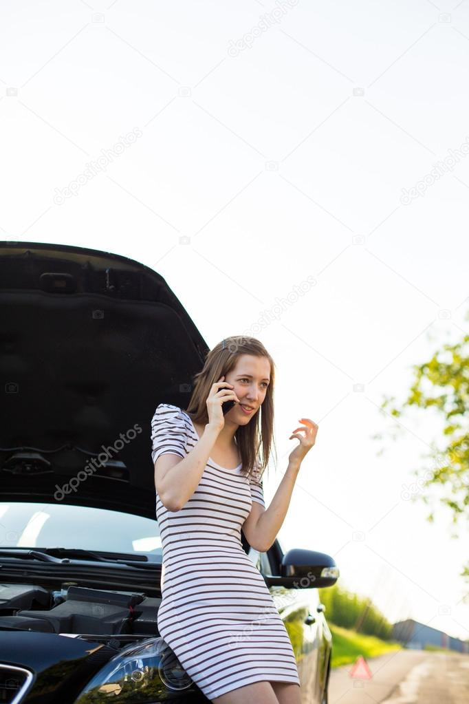Woman calling the roadside service, assistance