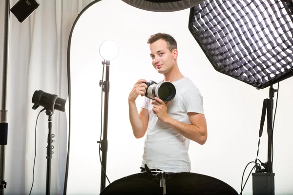 Young pro photographer with digital camera — Stock Photo, Image