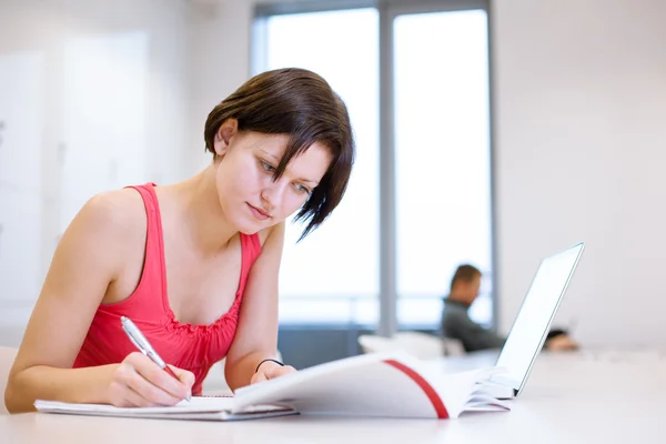 College student girl studying in the library — Stock Photo, Image