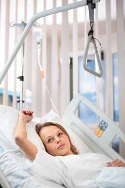 Female patient in a modern hospital room clipart