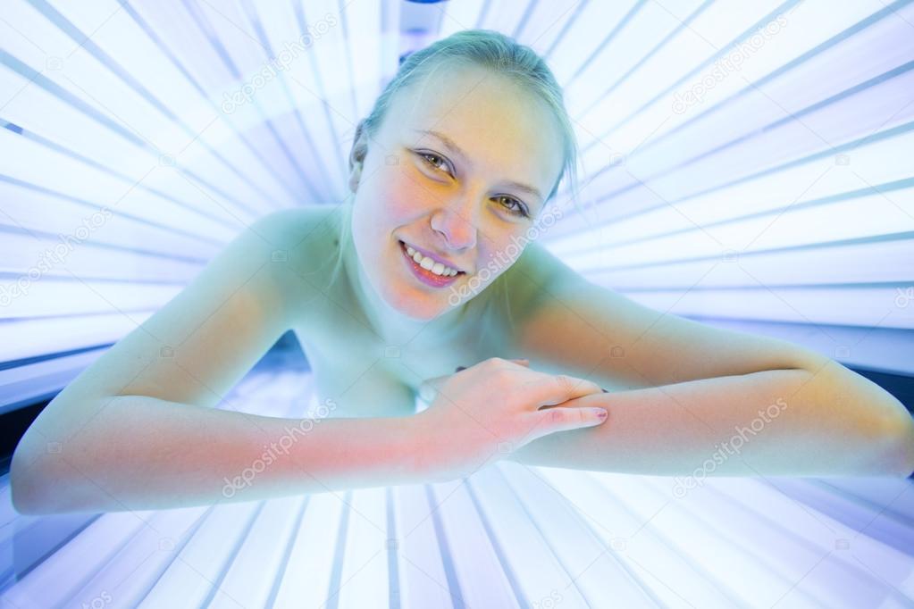 Woman tanning her skin in a modern solarium