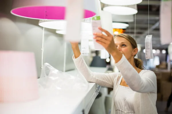 Mujer eligiendo la luz adecuada para su apartamento — Foto de Stock