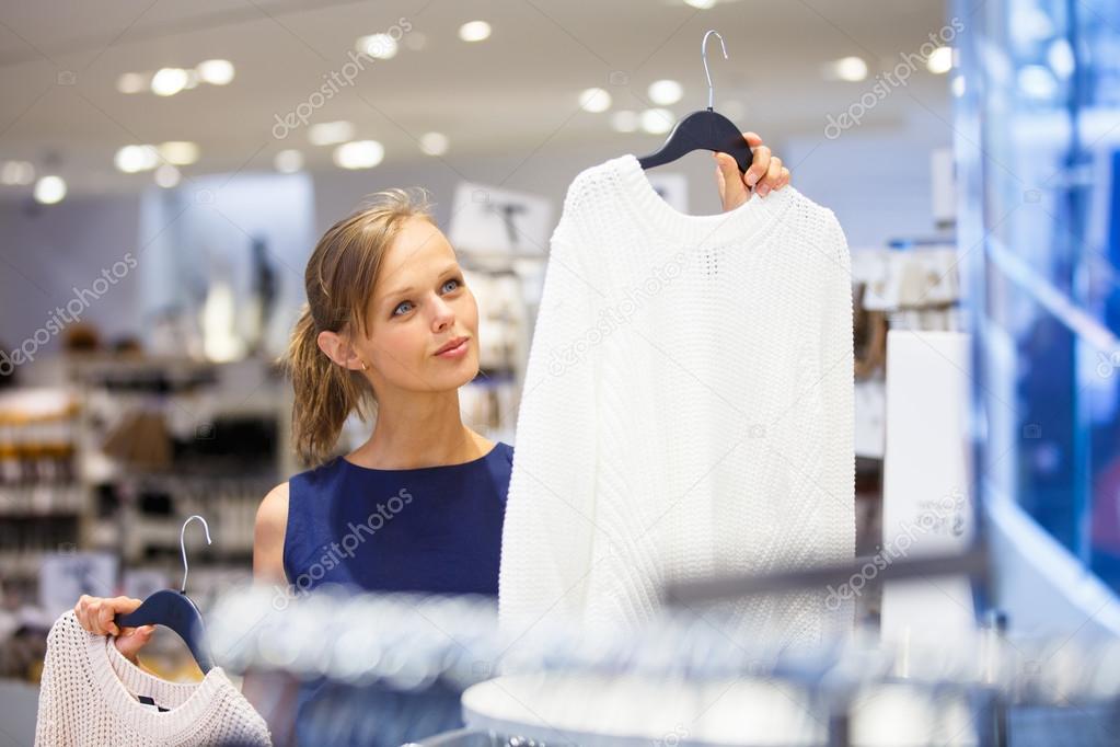 Beautiful young female shopper in a clothing store