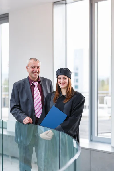 Female university graduate with her father — Stock Photo, Image