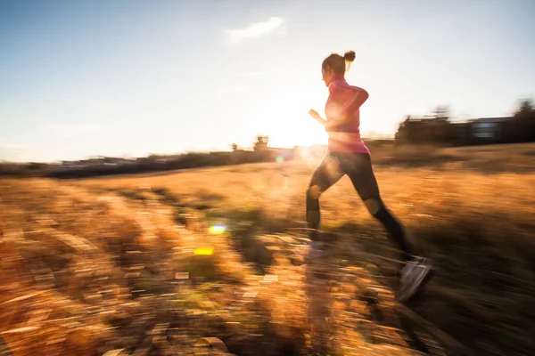 Woman running outdoors on a lovely sunny winter or fall day — Stock Photo, Image