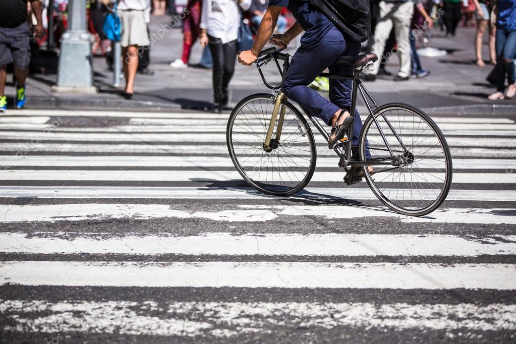 Man on a bike on a crossing in Manhattan