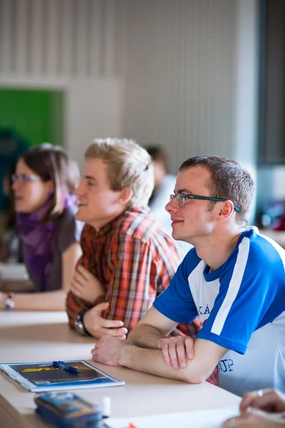 英俊的大学学生坐在教室里 — 图库照片