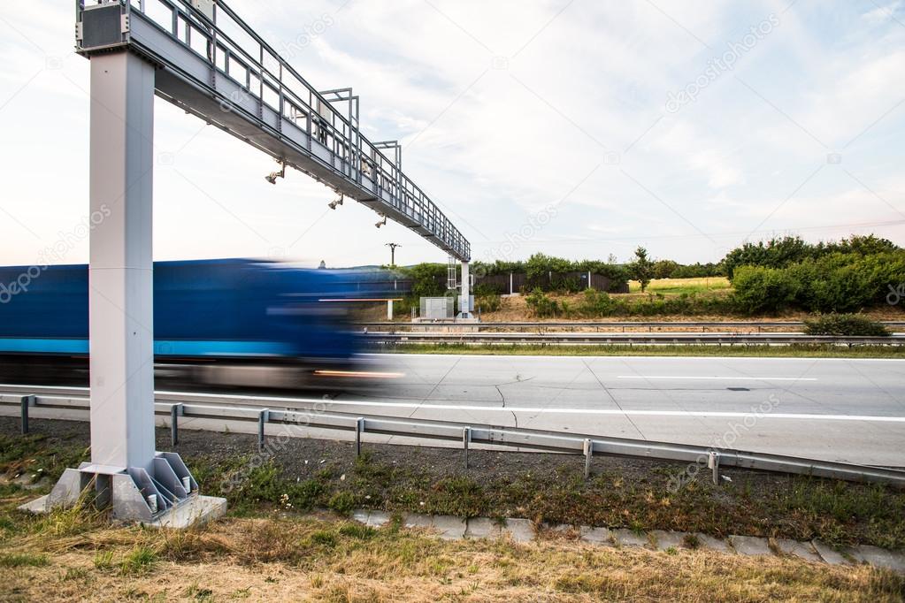 Truck passing through a toll gate on a highway