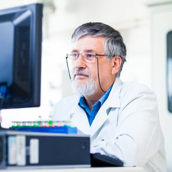 Pesquisador sênior usando um computador no laboratório — Fotografia de Stock